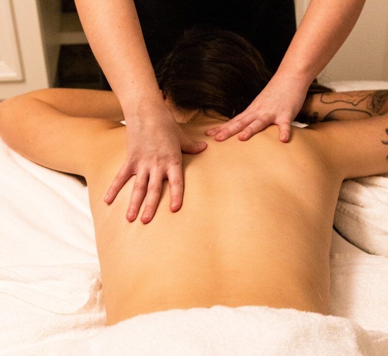 a woman getting a back massage at a spa